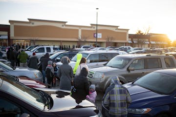 Dozens of people waited in a line that wound through the parking lot of the COVID-19 community testing site in Brooklyn Park in early January.