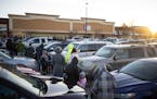 Dozens of people waited in a line that wound through the parking lot of a COVID-19 community testing site in Brooklyn Park in early January.