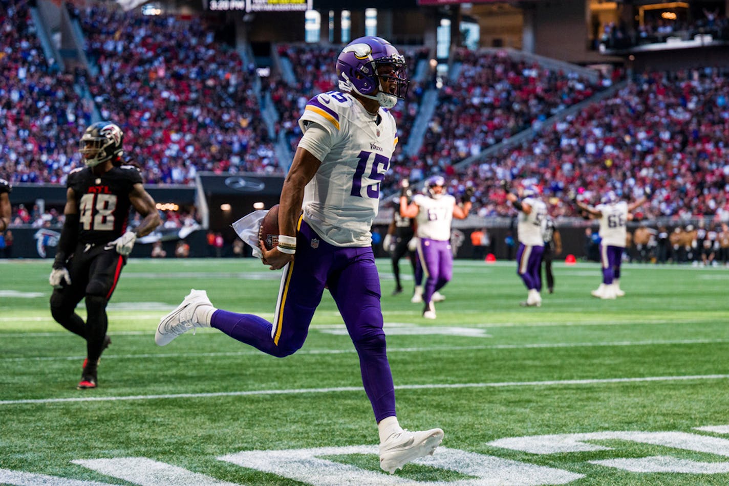 Minnesota Vikings quarterback Joshua Dobbs (15) runs the ball into the end zone for a touchdown during the second half of an NFL football game against the Atlanta Falcons, Sunday, Nov. 5, 2023, in Atlanta. The Minnesota Vikings won 31-28. (AP Photo/Danny Karnik)