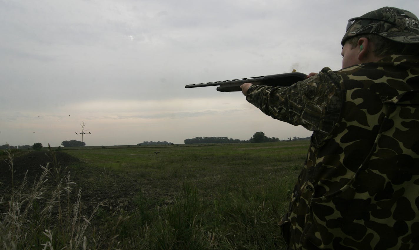 Graham Smith, 11, of Lakeville, fires at some mourning doves on the opening day of Minnesota's mourning dove season. Graham bagged three birds on his first-ever hunt.