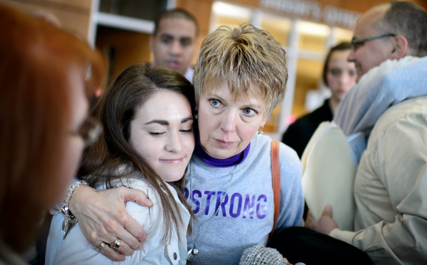 Isaac Kolstad's wife Molly and mother Teresa hugged after the Nelson's sentencing. ] GLEN STUBBE * gstubbe@startribune.com Former Minnesota quarterback Philip Nelson was sentenced Monday for his role in the bar-closing time assault on Isaac Kolstad.