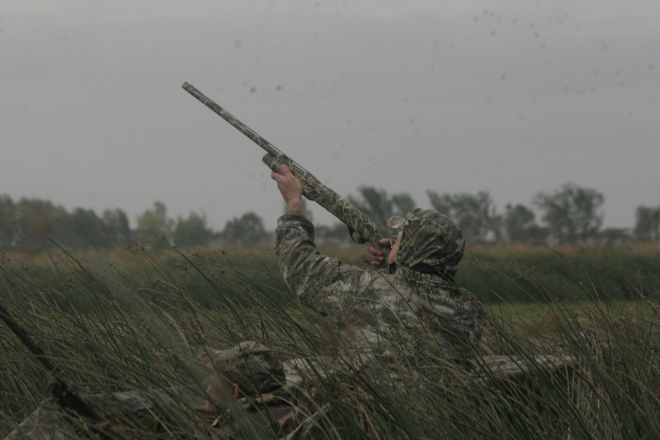Fred Froehlich, 58, of Nicollet, Minn., fires at a duck that buzzed his decoys.