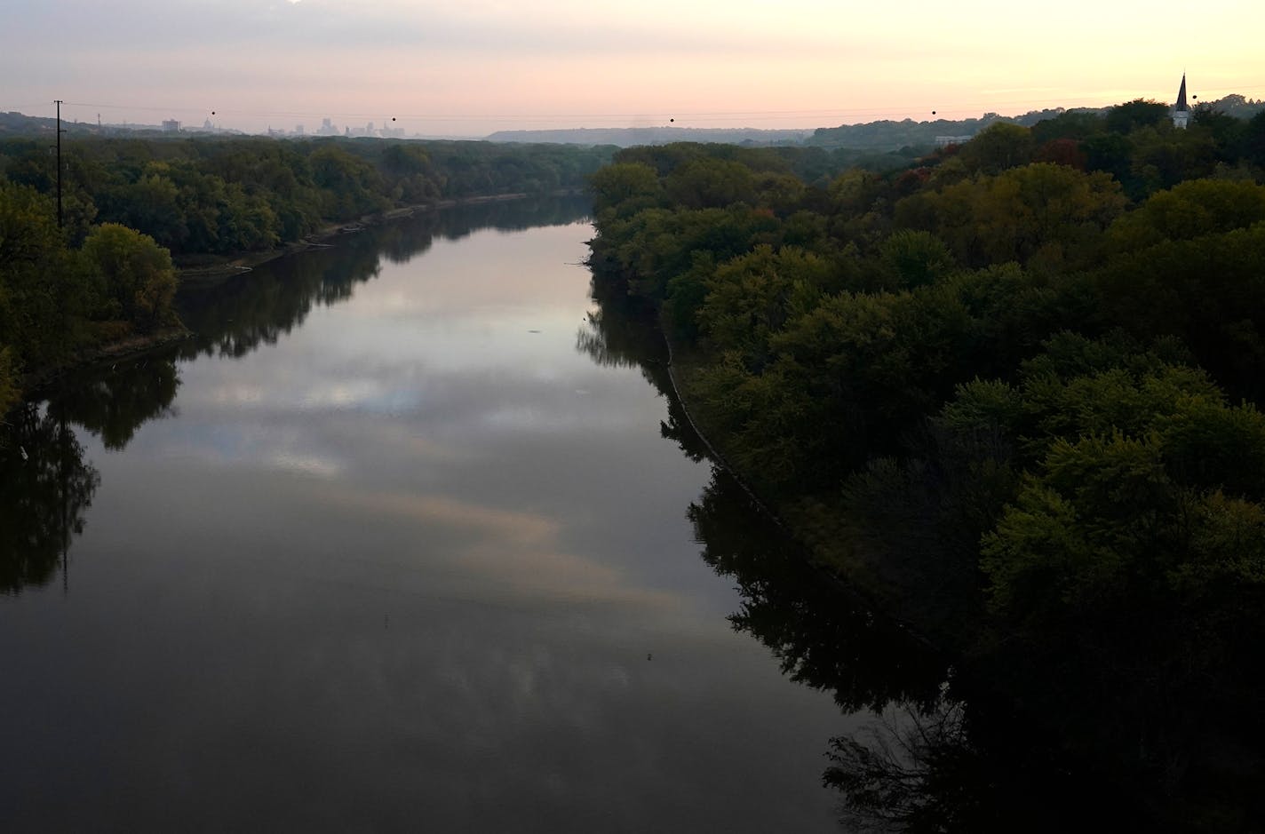 A calm Minnesota River reflected clouds during the morning hours as St. Paul was visible to the rear, seen from the Mendota Bridge Friday in Mendota Heights. ]