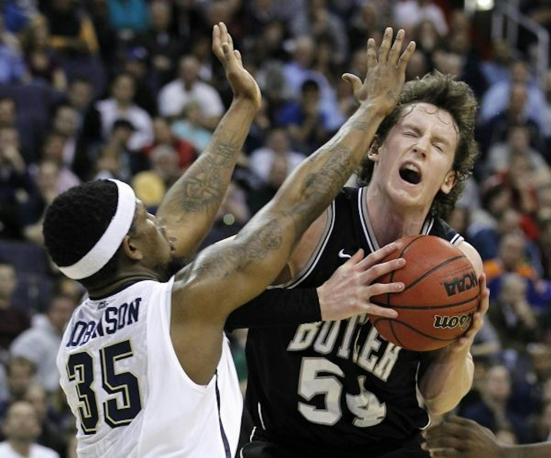 Butler forward Matt Howard, right, collides with Pittsburgh forward Nasir Robinson during the second half of the Southeast Regional third-round NCAA tournament college basketball game, Saturday, March 19, 2011, at the Verizon Center in Washington.