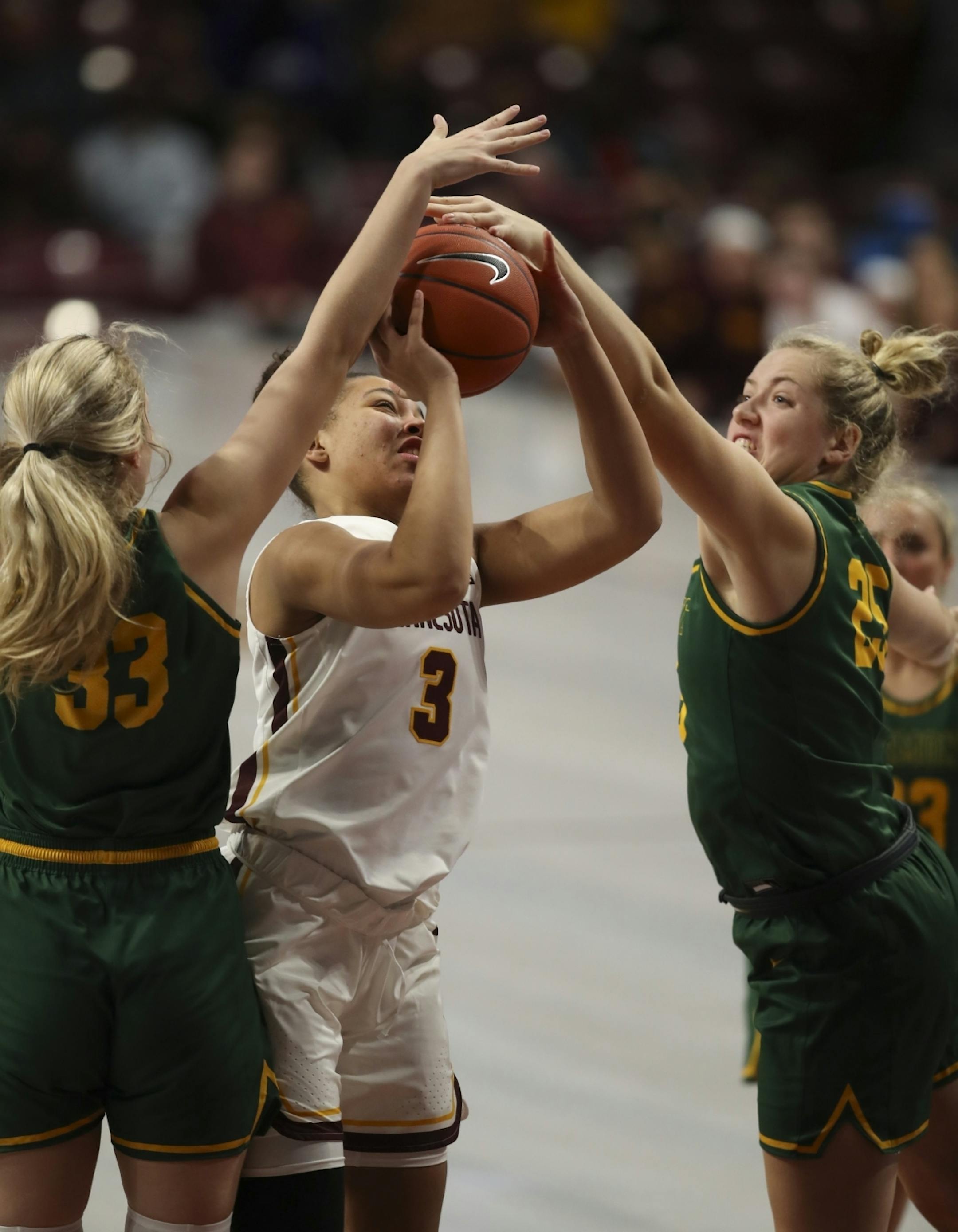 Minnesota Golden Gophers guard Destiny Pitts (3) was double teamed by Vermont Catamounts forwards Delaney Richason (33) and Abby Settelmeyer (25) in the second quarter.