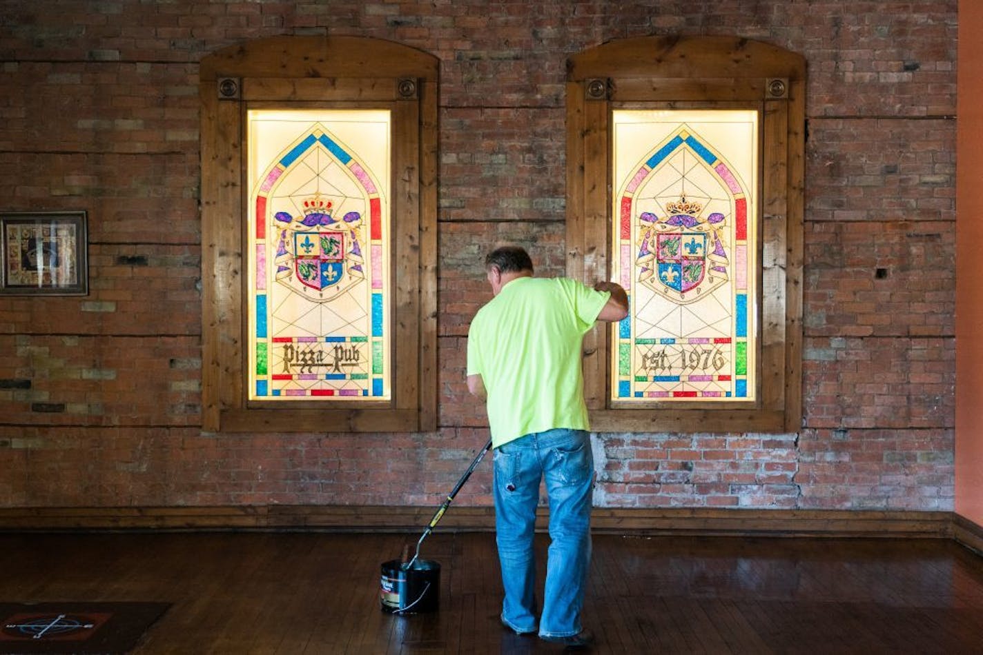 Rick Herzog, who has run the Pizza Pub for 30 years, is refinishing his floors while the 240-seat dinning room sits empty. Herzog says his already established takeout business remains strong.