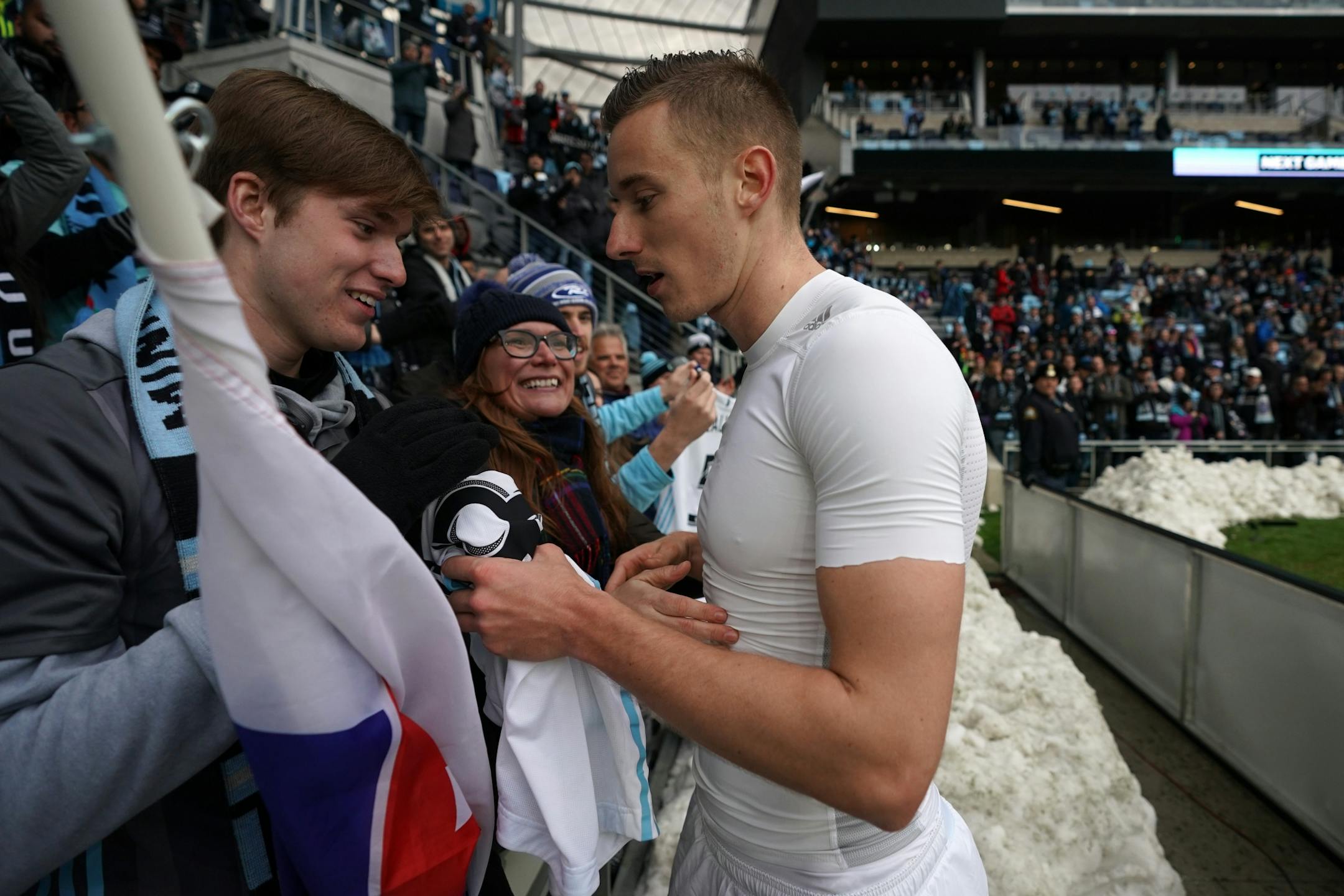 Minnesota United midfielder Jan Gregus (8) gave his jersey and a hug to Henry Purdy of Shakopee as he stood with his mom Silvia in the stands after the tie at the end of the second half.