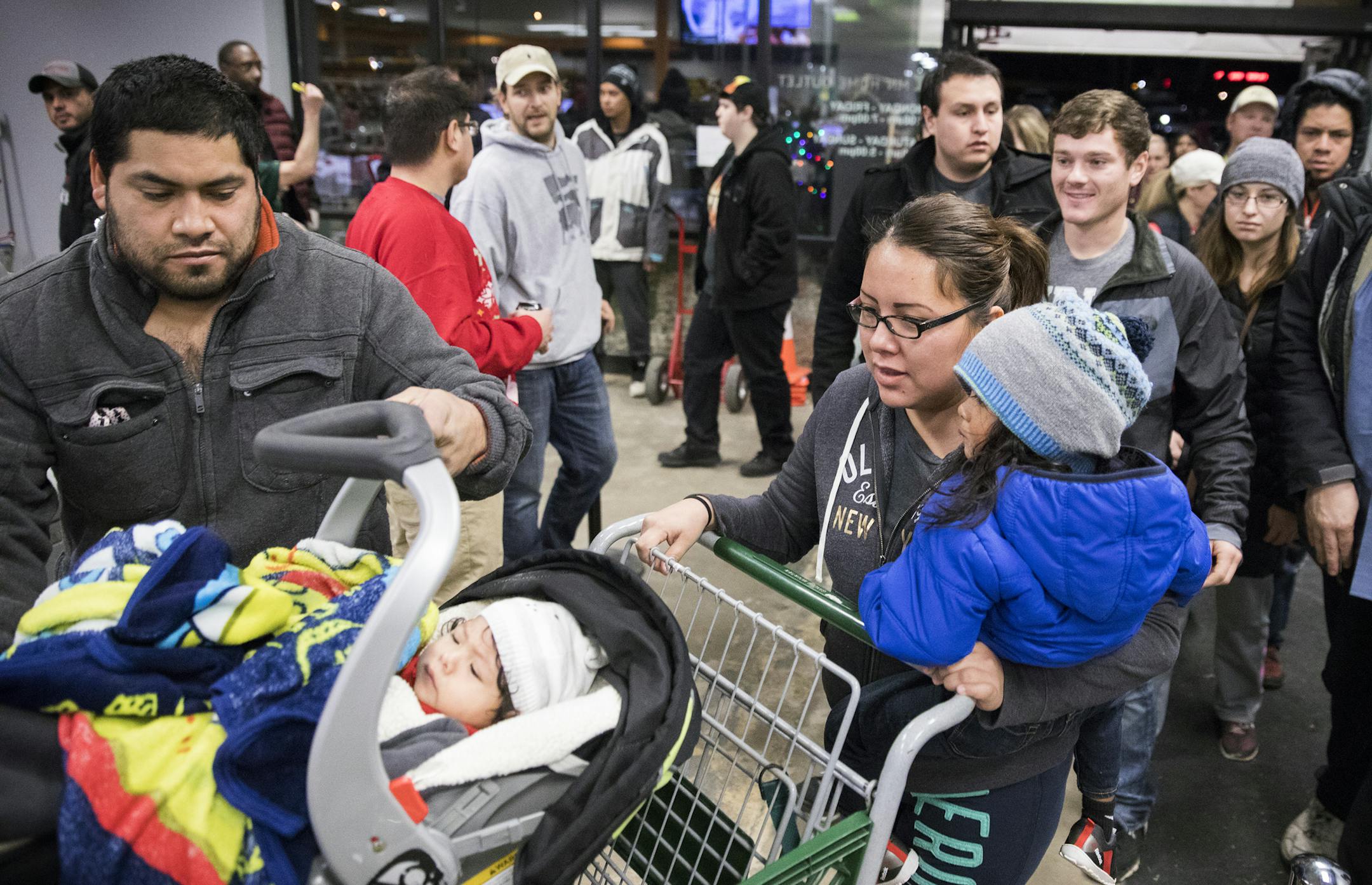 The first rush of customers enters MN Home Outlet at 6 a.m. on Black Friday. ] LEILA NAVIDI ï leila.navidi@startribune.com BACKGROUND INFORMATION: MN Home Outlet in Burnsville, which discounts everything 50% on Black Friday, November 24, 2017. About 100 shoppers were lined up before 6 a.m. when the store opened.