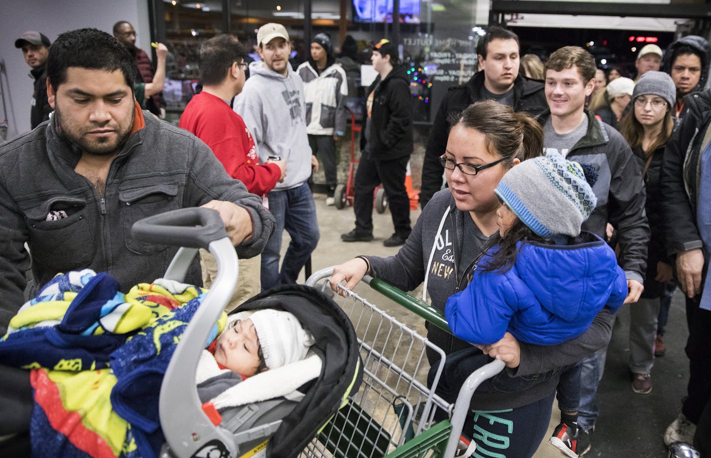 The first rush of customers enters MN Home Outlet at 6 a.m. on Black Friday. ] LEILA NAVIDI &#xef; leila.navidi@startribune.com BACKGROUND INFORMATION: MN Home Outlet in Burnsville, which discounts everything 50% on Black Friday, November 24, 2017. About 100 shoppers were lined up before 6 a.m. when the store opened.