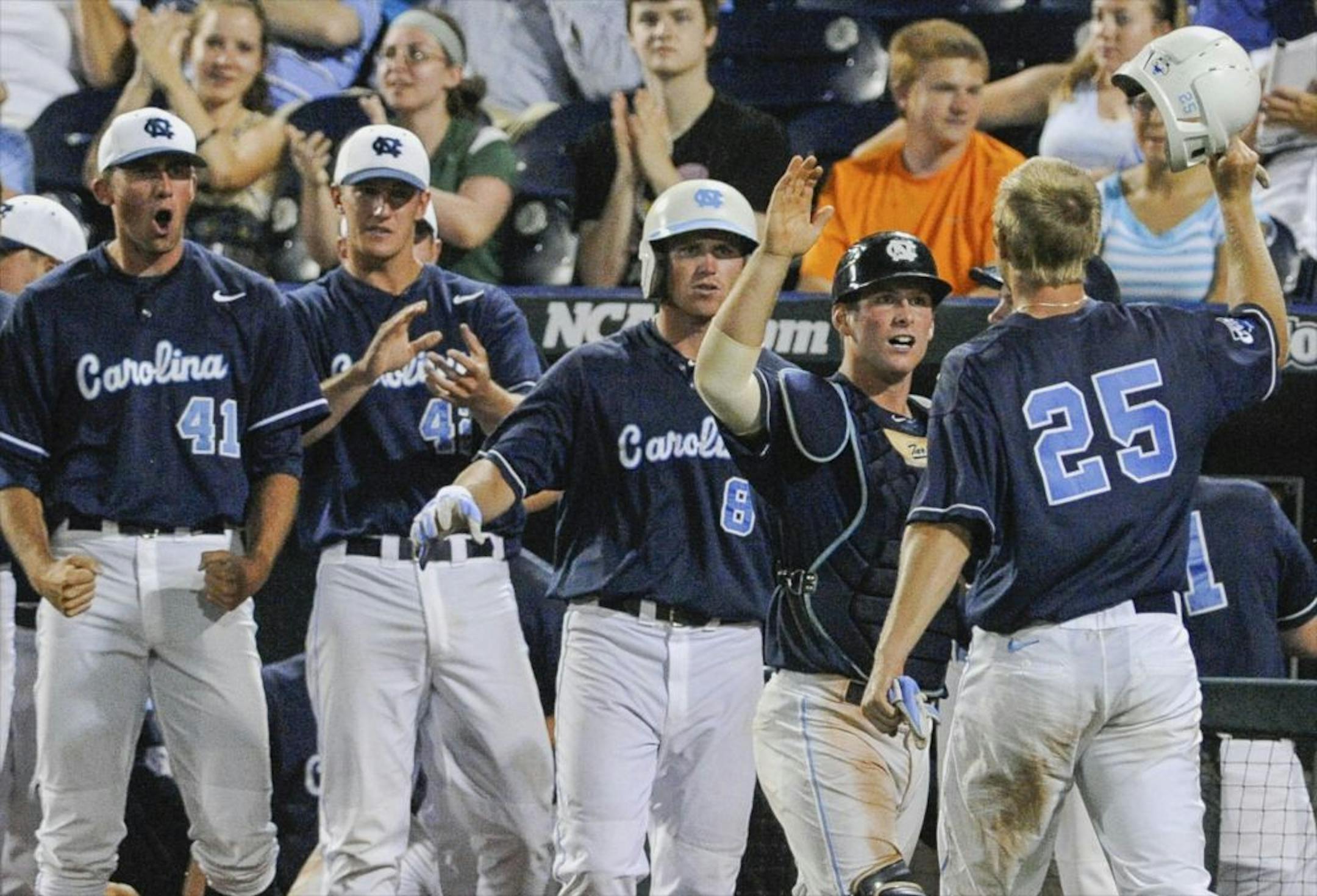 North Carolina's Cody Stubbs (25) celebrates with teammates after he scored against North Carolina State on a two-RBI single by Michael Russell in the eighth inning of an NCAA College World Series elimination game.