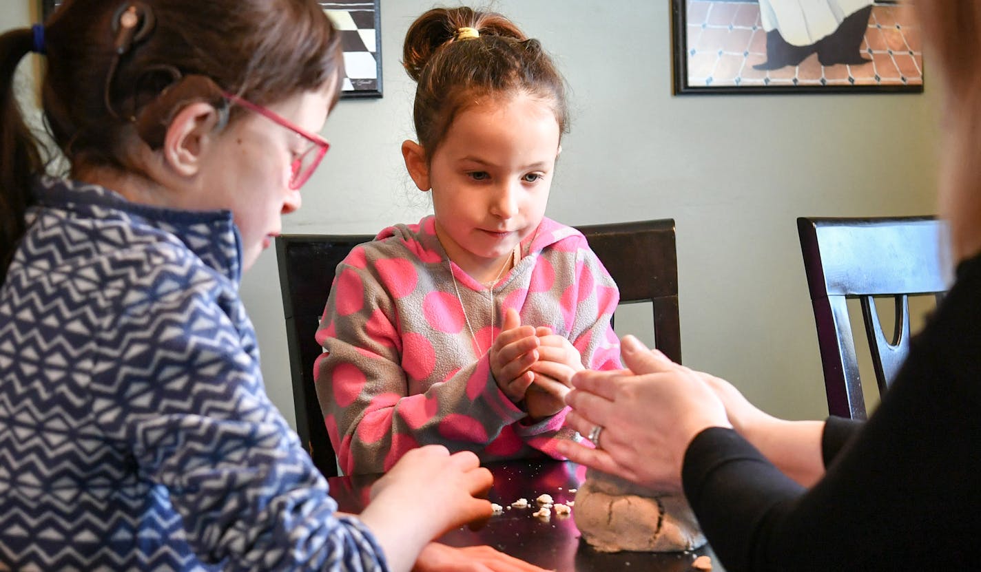 After an anxiety-filled evening waiting for her first grade daughter Avery, 6, who was stuck on a St. Paul school bus for three hours, Jodi Meerovich was happy to have her daughters Avery and Marisa, 10, home for a quiet snow day where they made sand castles and a sand man (like a snowman, but made of sand) Marisa is a blue sweater, Avery is in pink. Jodi wanted better communication between delayed busses, she had learned on facebook that Avery's bus had been in an accident. ] GLEN STUBBE &#xef;