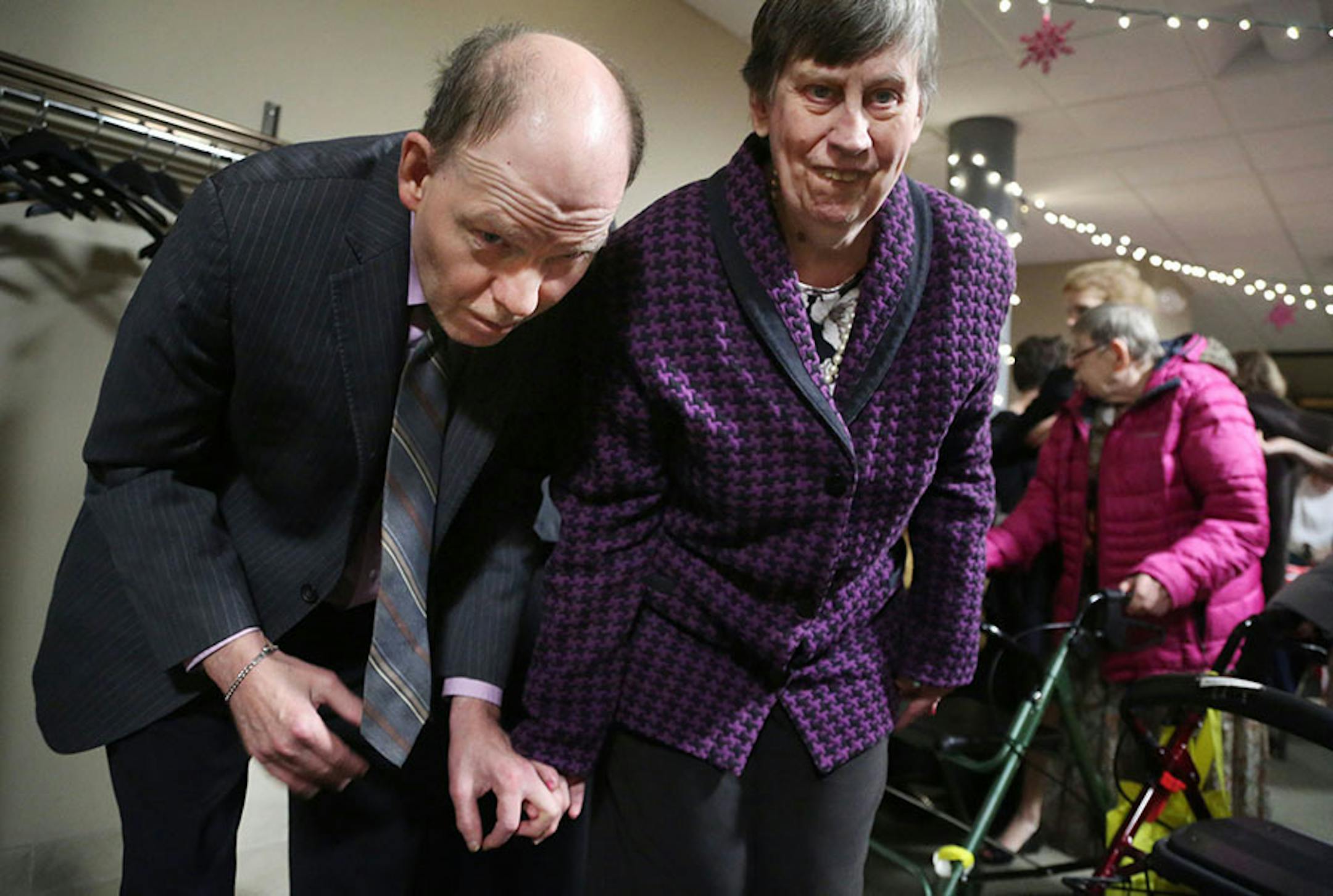James Aitken, left, and Mary Day, from the Bethesda Lutheran Communities in Victoria, make their way into the Snowflake Ball Saturday, Feb. 20, 2016, at Ridgewood Church in Minnetonka.