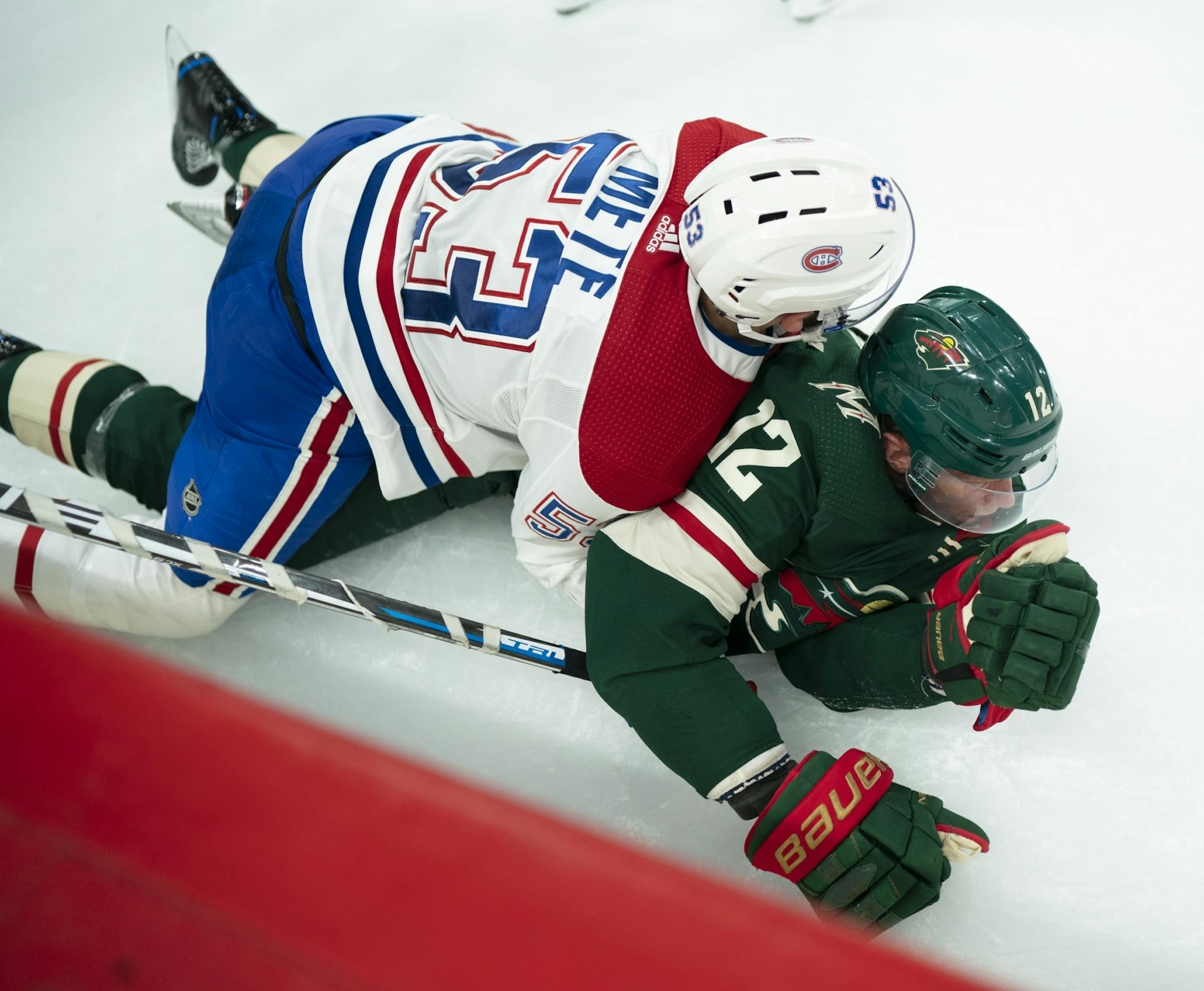 Montreal Canadiens defenseman Victor Mete (53) rode Minnesota Wild center Eric Staal (12) after bringing him down at mid-ice in the third period.