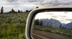 FILE &#xf3; The Teton Range reflected in the rear-view mirror during a road trip through Wyoming, June 16, 2015. Drivers should make sure their vehicl
