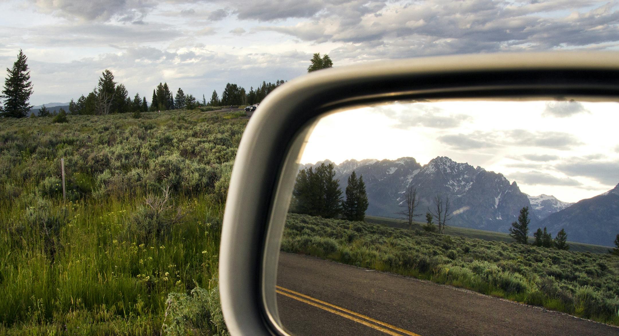 FILE ó The Teton Range reflected in the rear-view mirror during a road trip through Wyoming, June 16, 2015. Drivers should make sure their vehicles are ready and know what to do in an emergency when planning a road trip. (Janie Osborne/The New York Times) ORG XMIT: XNYT48