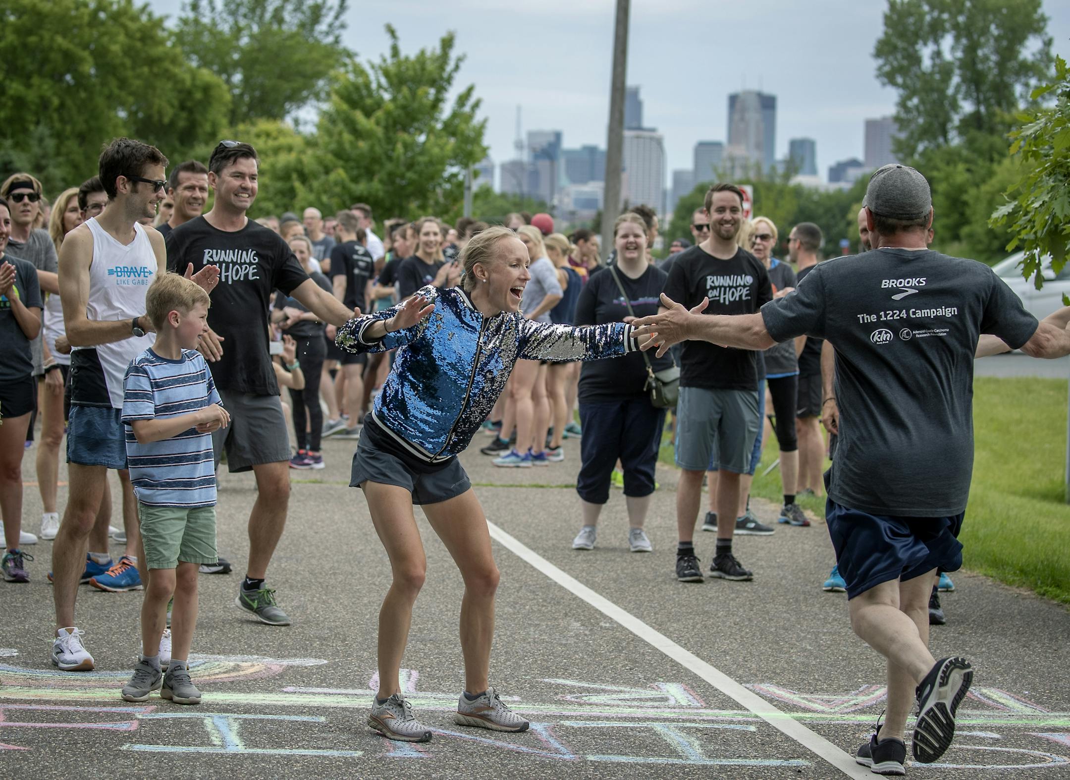 Gabriele Grunewald's running teammate and best friend Ladia Albertsonb-Junkans greeted family, friends, and supporters after they crossed the finish line following a one-mile run/jog/walk in honor Gabriele just outside Hillside Cemetery.