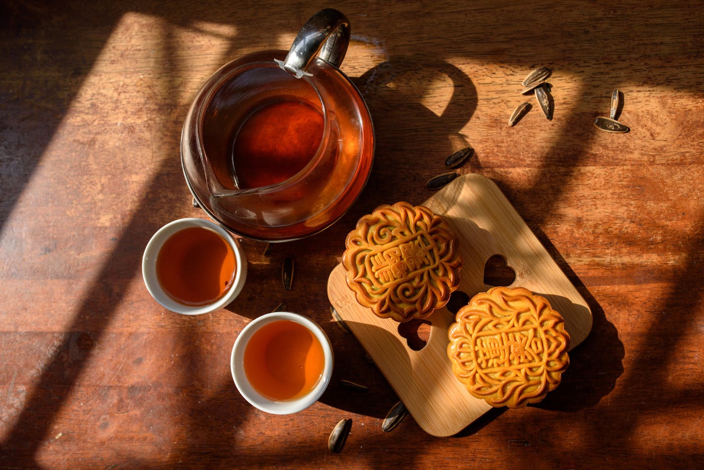 Image of Chinese traditional festival mid-autumn Moon cake and Tea. Chinese word on moon cake mean lotus seed paste and Jade Pandan paste.