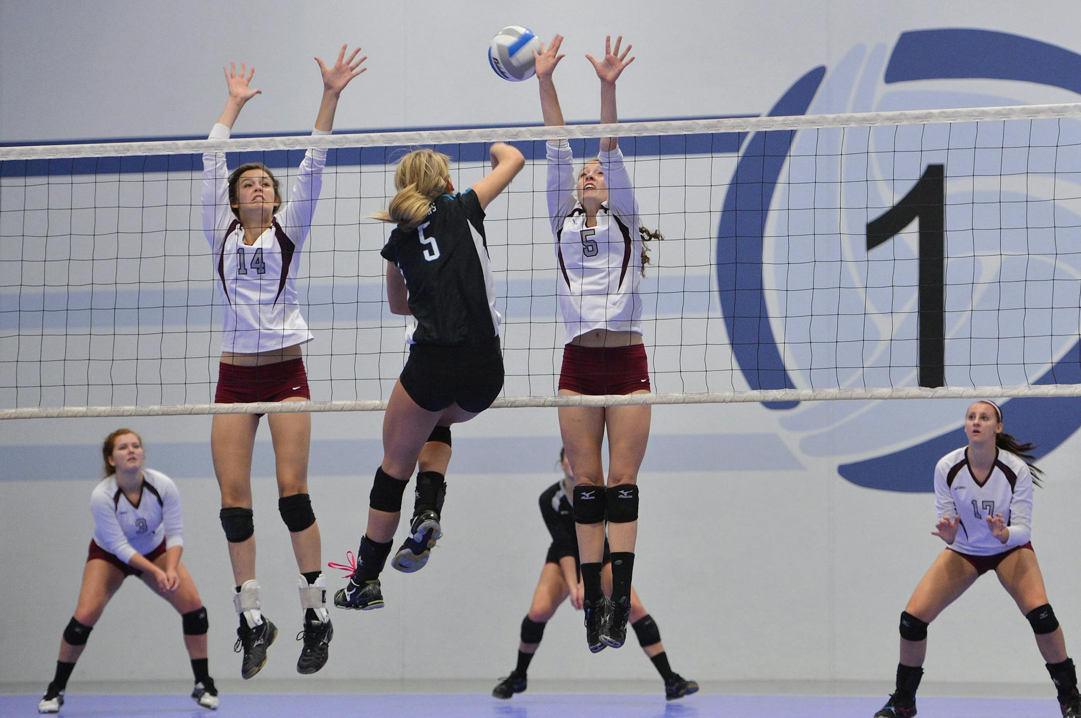 Southwest Christian's Abby Palkert and Abby VanderGalien go up to block Fillmore Central's Victoria Peterson's spike during a semifinal match of the Minnesota Class 1A Showcase tournament Saturday, September 21 at Midwest Volleyball Warehouse in Burnsville. ] (SPECIAL TO THE STAR TRIBUNE/BRE McGEE) **Abby Palkert (14), Abby VanderGalien (white, 5), Victoria Peterson (black, 5) ORG XMIT: MIN1309211731081245