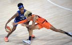 Connecticut Sun guard Natisha Hiedeman, right, attempts to steal a ball from Minnesota Lynx guard Crystal Dangerfield (2) during the first half of a W