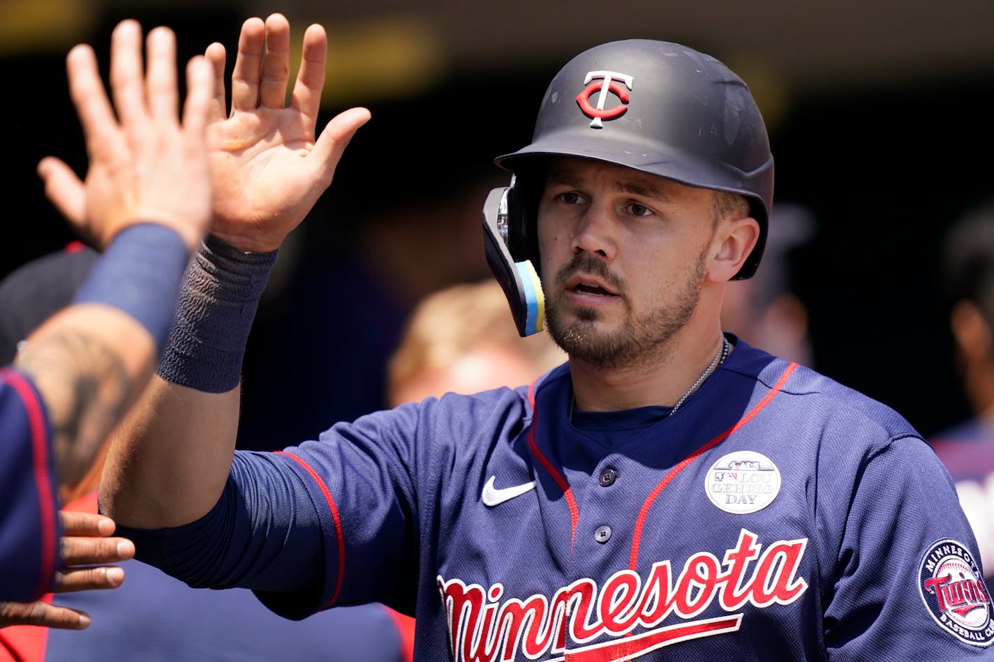 Minnesota Twins' Trevor Larnach is greeted in the dugout after scoring on Nick Gordon's double to center during the fourth inning of a baseball game against the Detroit Tigers, Thursday, June 2, 2022, in Detroit. (AP Photo/Carlos Osorio)