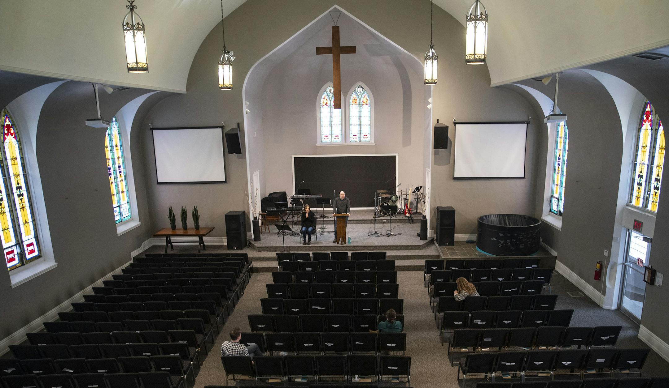 Kyle Eaton, the lead pastor at Rock Hill community church, preached to a nearly empty room while being live streamed. The only people in the seats were members of the church band and a fellow pastor, who all practiced social distancing. "We normally draw in about 500 people each week, but last Sunday we had 5,000 people watching the live stream," Eaton said. ] ALEX KORMANN • alex.kormann@startribune.com With a Stay At Home order in place across Minnesota, churches around the state are live strea