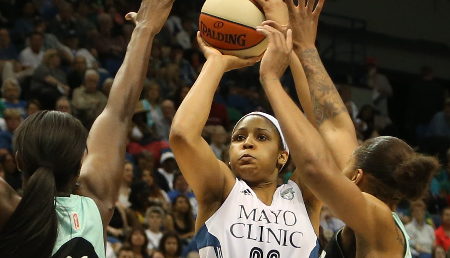 Lynx Maya Moore shot over the top of two Liberty' defenders for the basket during the second half. ] (KYNDELL HARKNESS/STAR TRIBUNE) kyndell.harkness@startribune.com Lynx won over New York Liberty87-82 at the Target Center in Minneapolis Min. Saturday, May 24, 2014.