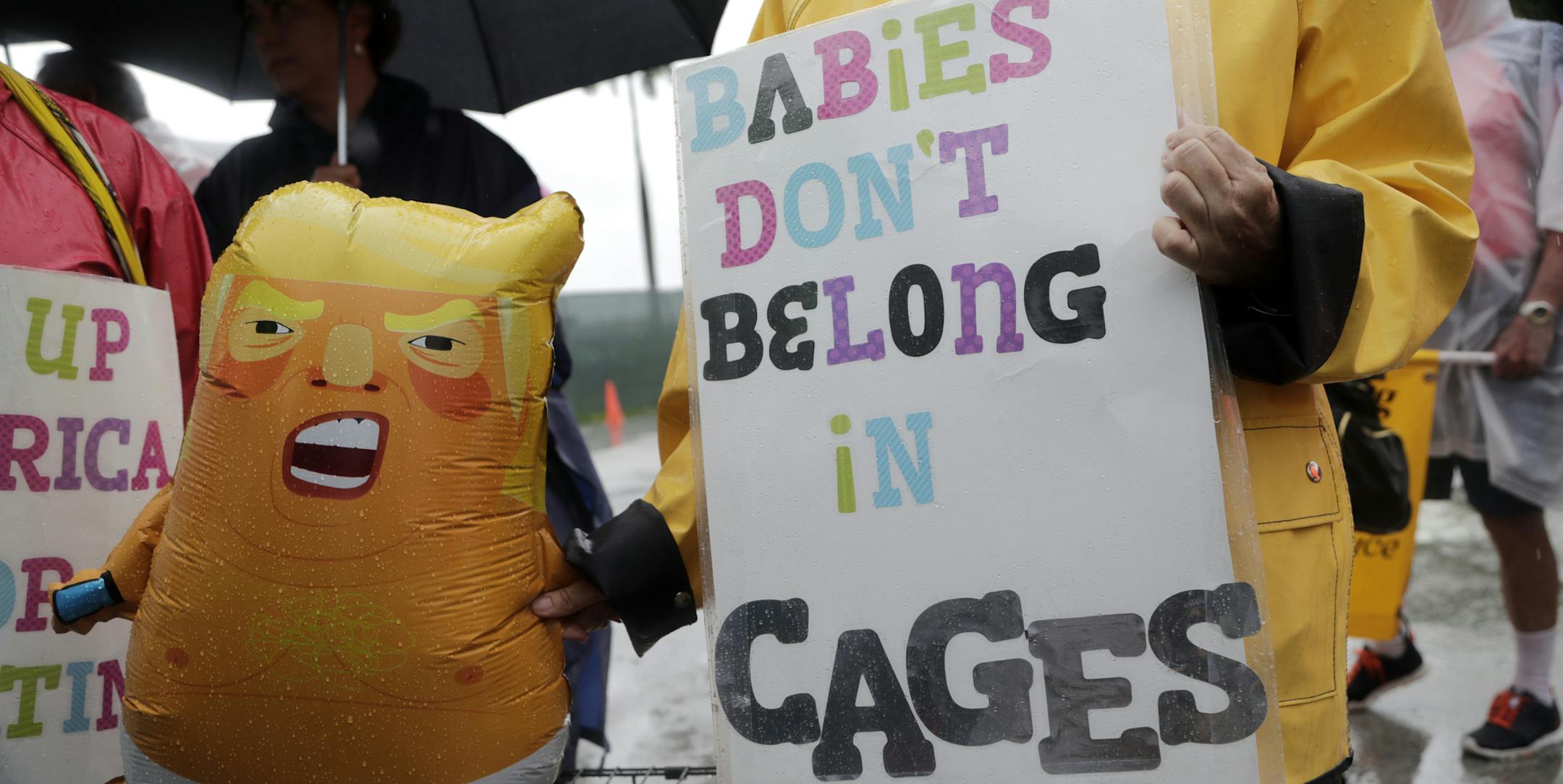 Protesters hold an inflatable doll in the likeness of President Donald Trump outside of the Homestead Temporary Shelter for Unaccompanied Children, Sunday, June 16, 2019, in Homestead, Fla. A coalition of religious groups and immigrant advocates said they want the Homestead detention center closed. (AP Photo/Lynne Sladky)
