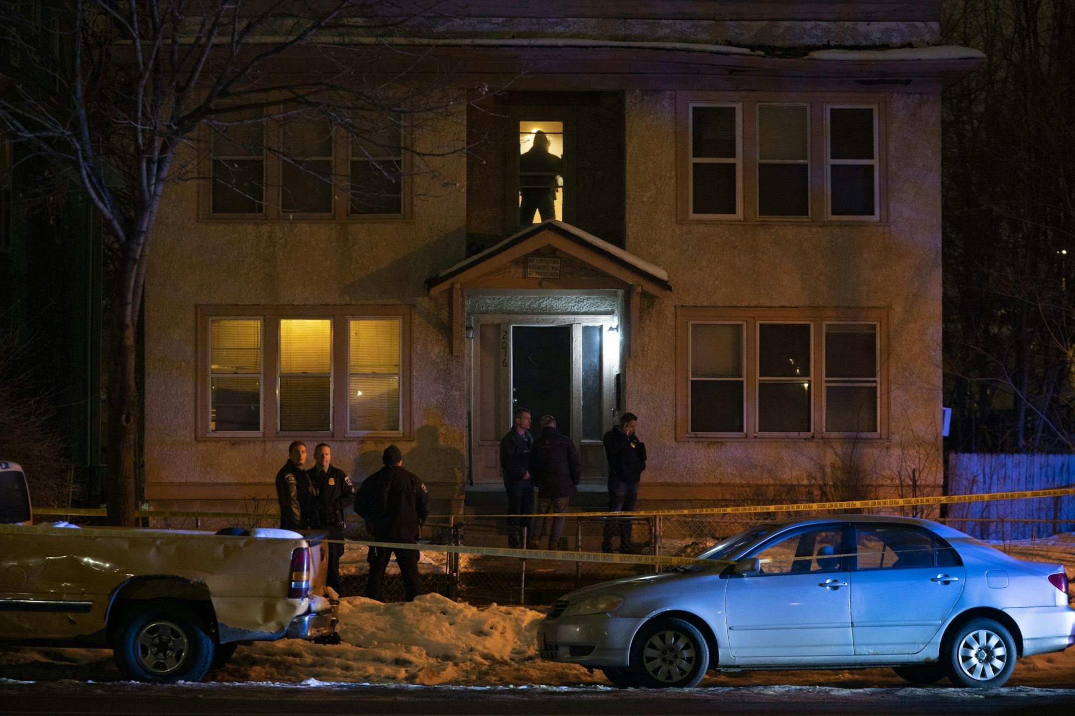 Police officers stood outside while investigators began their work on the second floor of a building in the 2000 block of Portland Ave. S. Sunday night.