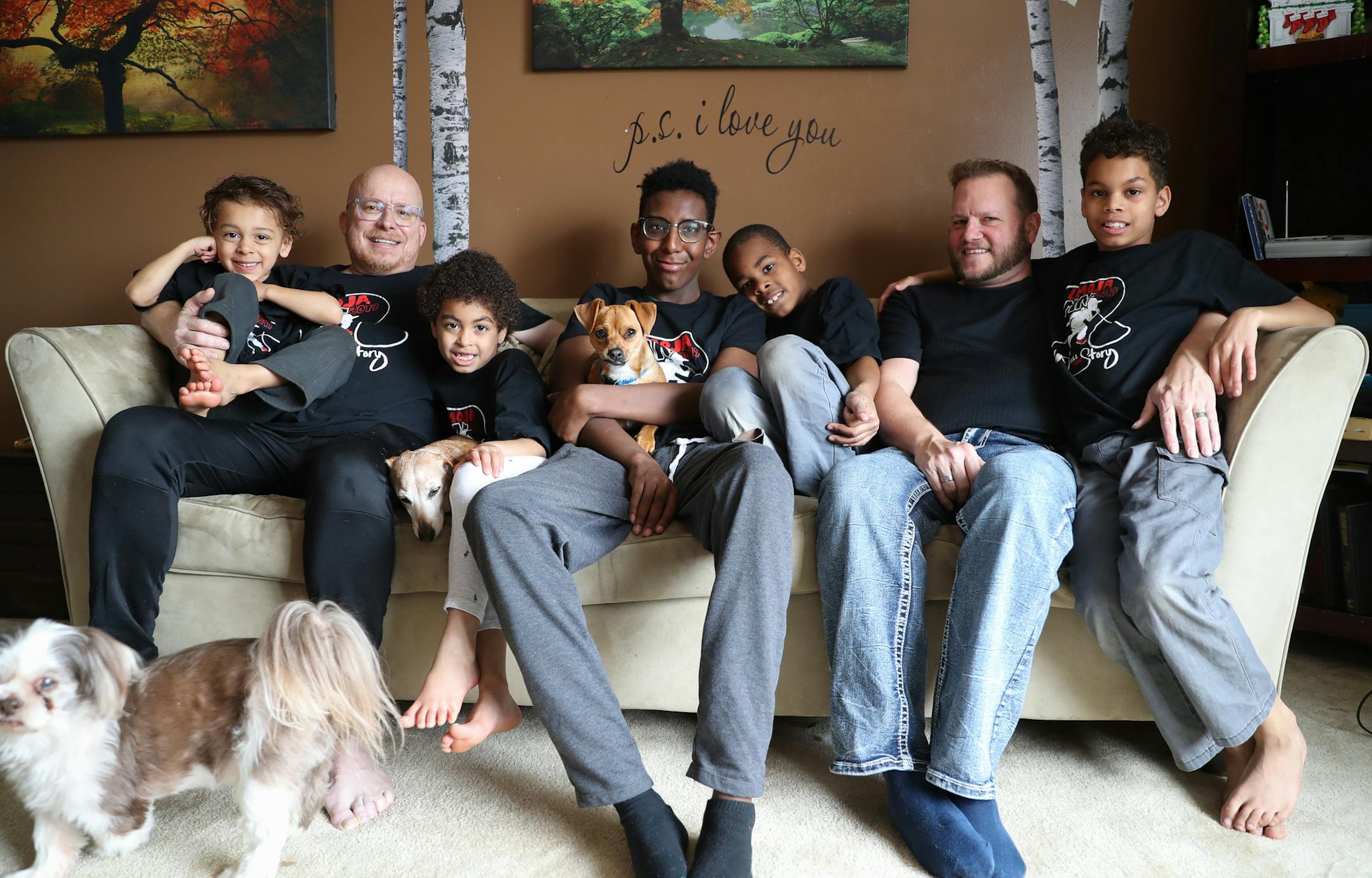 The Carlson-Oknich family (from left): Ethan (3), Joe, Adoria (6), Darious (16),Elijah (9), John and Brent (10). ] Shari L. Gross &#x2022; shari.gross@startribune.com Umoja is a Minnesota "heritage camp" aimed at transracial families who want to connect with their adopted children's heritage. Portrait of the Carlson-Oknich family, a white couple that has adopted five black children.