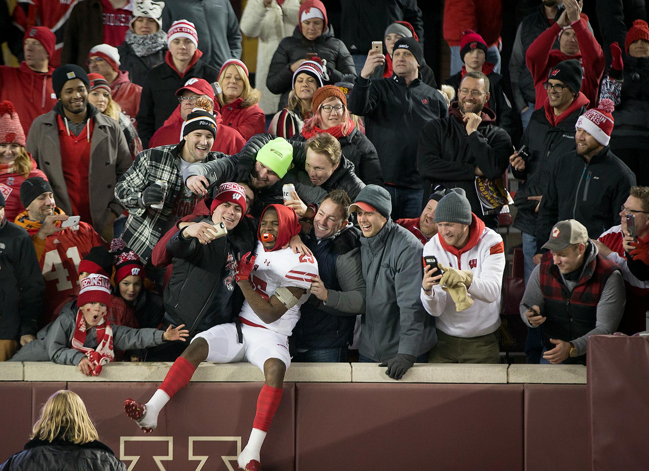Wisconsin's Derrick Tindal jumped into the stands to celebrate the Badgers' 31-0 blowout against the Gophers.
