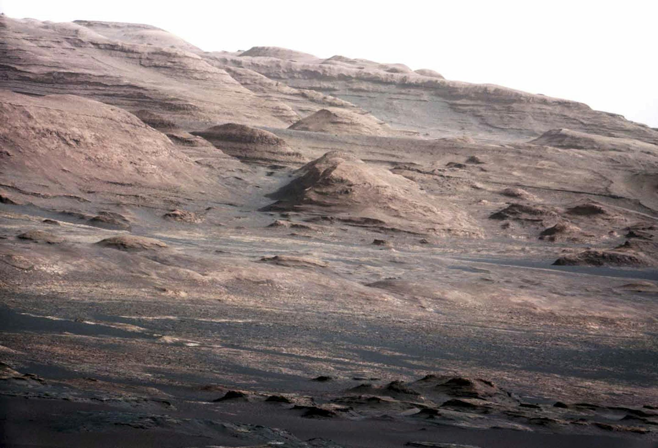 An undated handout image of landscape at the base of Mount Sharp on Mars, taken through a telephoto lens by NASA's Curiosity rover. The rover is expected to reach the 3.4-mile-high peak in about a year, and the layered surface of the mountain should yield information to scientists on the planet's geological history. (Malin Space Science Systems/NASA Jet Propulsion Laboratory via The New York Times) -- FOR EDITORIAL USE ONLY --