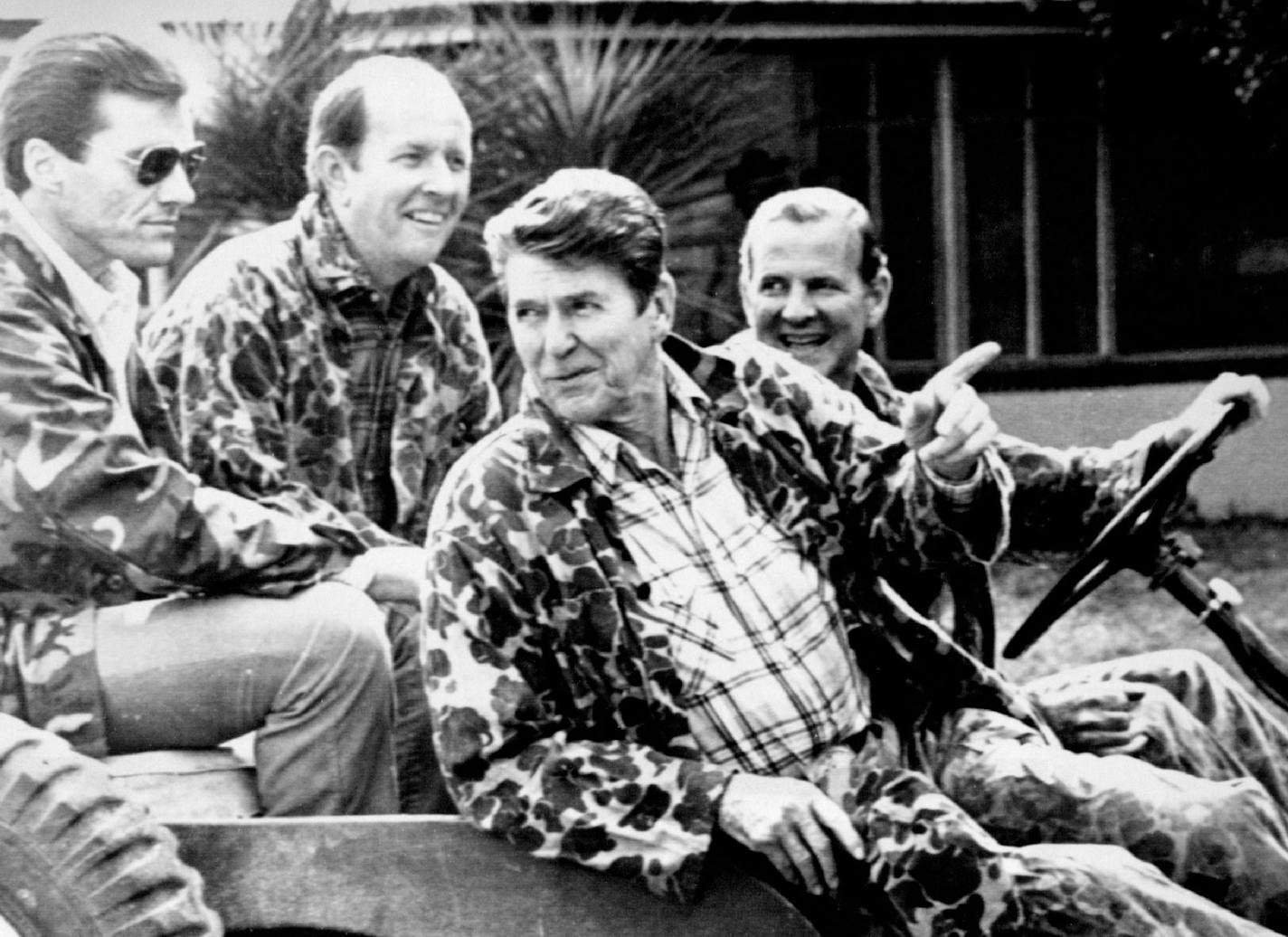 November 14, 1981 President Goes Hunting — President Ronald Reagan, Decked out in Camouflaged hunting Clothes, has a parting word for reporters as he leaves for a turkey hunt on a South Texas ranch Saturday. At the wheel of the Jeep is his chief of staff, James Baker. In back seat, Baker's ***** Michael Deaver, sits behind Baker and a secret service agent is beside him. November 15, 1981 IS, AP Laserphoto