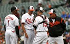 Baltimore Orioles starting pitcher Kevin Gausman, second from left, speaks with third baseman Tim Beckham (1), catcher Chance Sisco and pitching coach