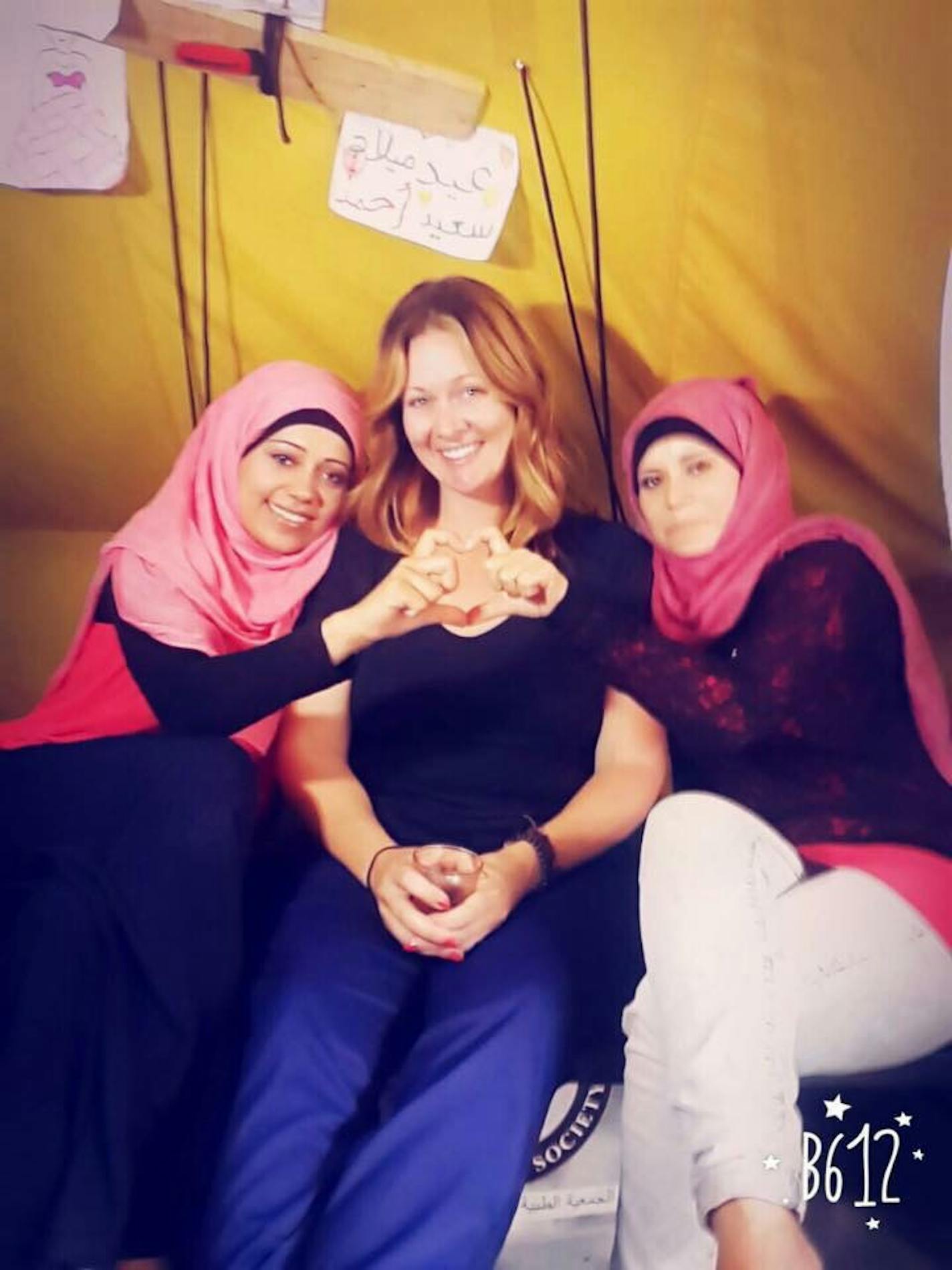 Lindsey Smith and two Syrian women at a Greek miltary camp in 2016.