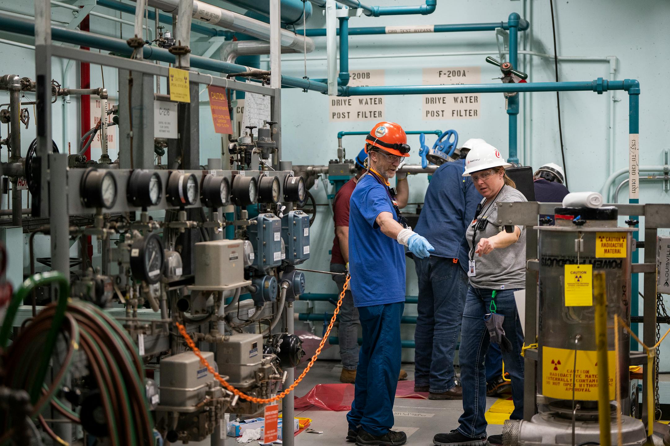 Workers talk while working inside the reactor building of Xcel Energy Monticello Nuclear Generating Plant.
