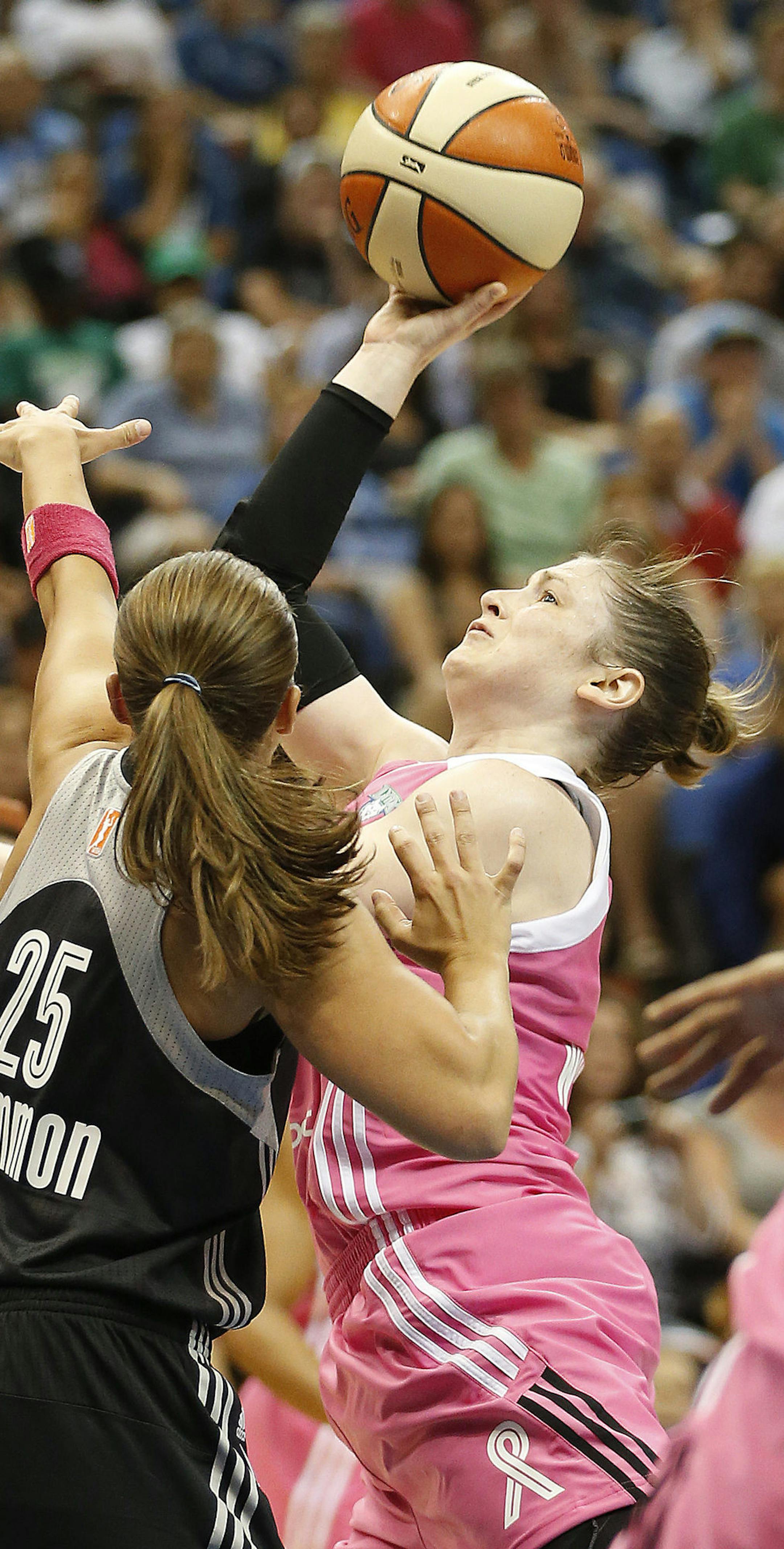 Minnesota Lynx guard Lindsay Whalen looks to shoot against San Antonio Stars guard Becky Hammon (25) during the first half of a WNBA basketball game, Friday, July 25, 2014, in Minneapolis. (AP Photo/Stacy Bengs)