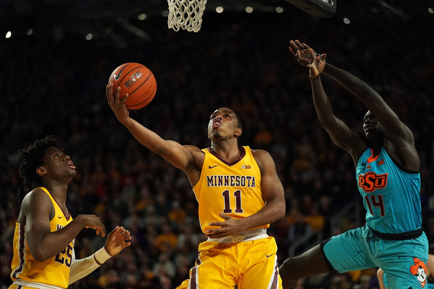 Minnesota Golden Gophers guard Isaiah Washington (11) went up for a shot as Oklahoma State Cowboys forward Yor Anei (14) jumped to defend in the first half. ] ANTHONY SOUFFLE &#x2022; anthony.souffle@startribune.com The Minnesota Golden Gophers played the Oklahoma State Cowboys in an NCAA men's basketball game Friday, Nov. 30, 2018 at U.S. Bank Stadium in Minneapolis, Minn. ORG XMIT: MIN1811302230491221