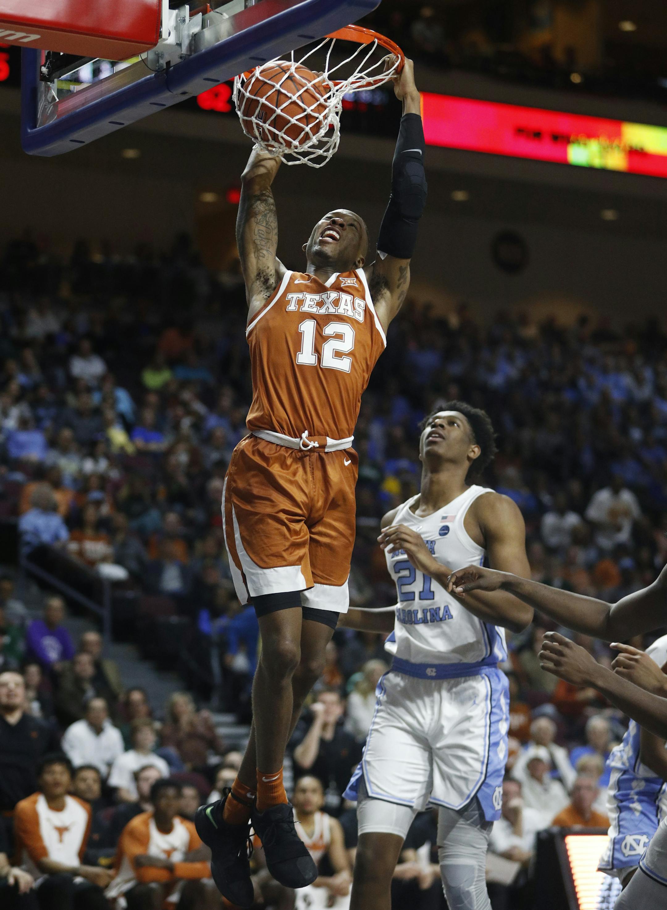 Texas' Kerwin Roach II (12) dunks against North Carolina during the second half of an NCAA college basketball game Thursday, Nov. 22, 2018, in Las Vegas. (AP Photo/John Locher)