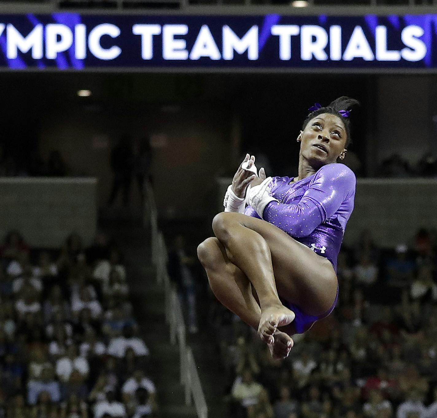 Simone Biles competes on the uneven bars during the women's U.S. Olympic gymnastics trials in San Jose, Calif., Friday, July 8, 2016. (AP Photo/Gregory Bull)