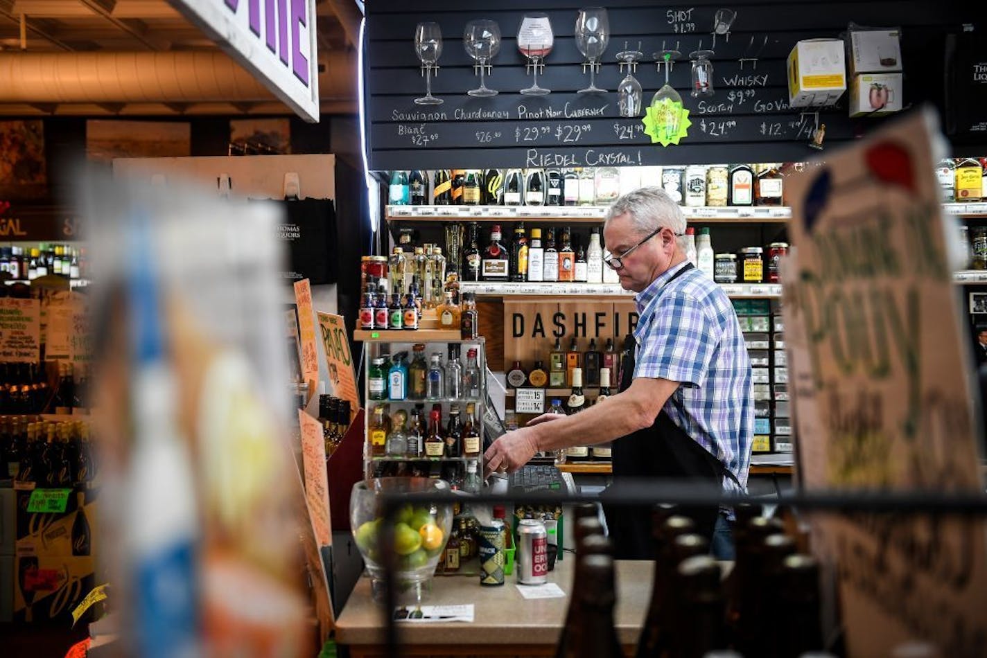 Mike Thomas worked behind the register Wednesday afternoon at Thomas Liquors/ 2