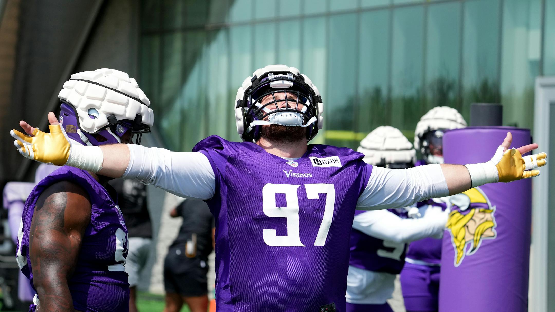 Minnesota Vikings defensive tackle Harrison Phillips (97) stretches out his arm to embrace a cool breeze during training camp.