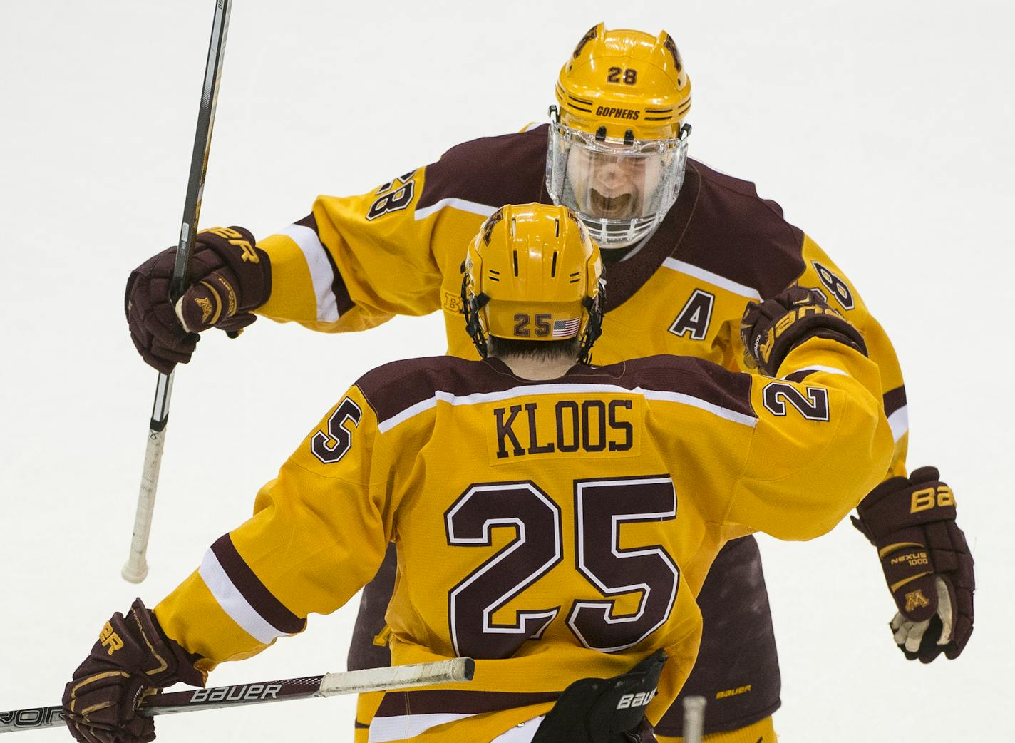 Minnesota Golden Gophers defenseman Jake Bischoff (28) and Gophers center Justin Kloos (25) celebrated a goal by Kloos in the second period Saturday against the Michigan Wolverines. ] (AARON LAVINSKY/STAR TRIBUNE) aaron.lavinsky@startribune.com The University of Minnesota Golden Gophers men's hockey team played the University of Michigan Wolverines in the Big Ten Tournament championship game on Saturday, March 19, 2016 at Xcel Energy Center in St. Paul, Minn.