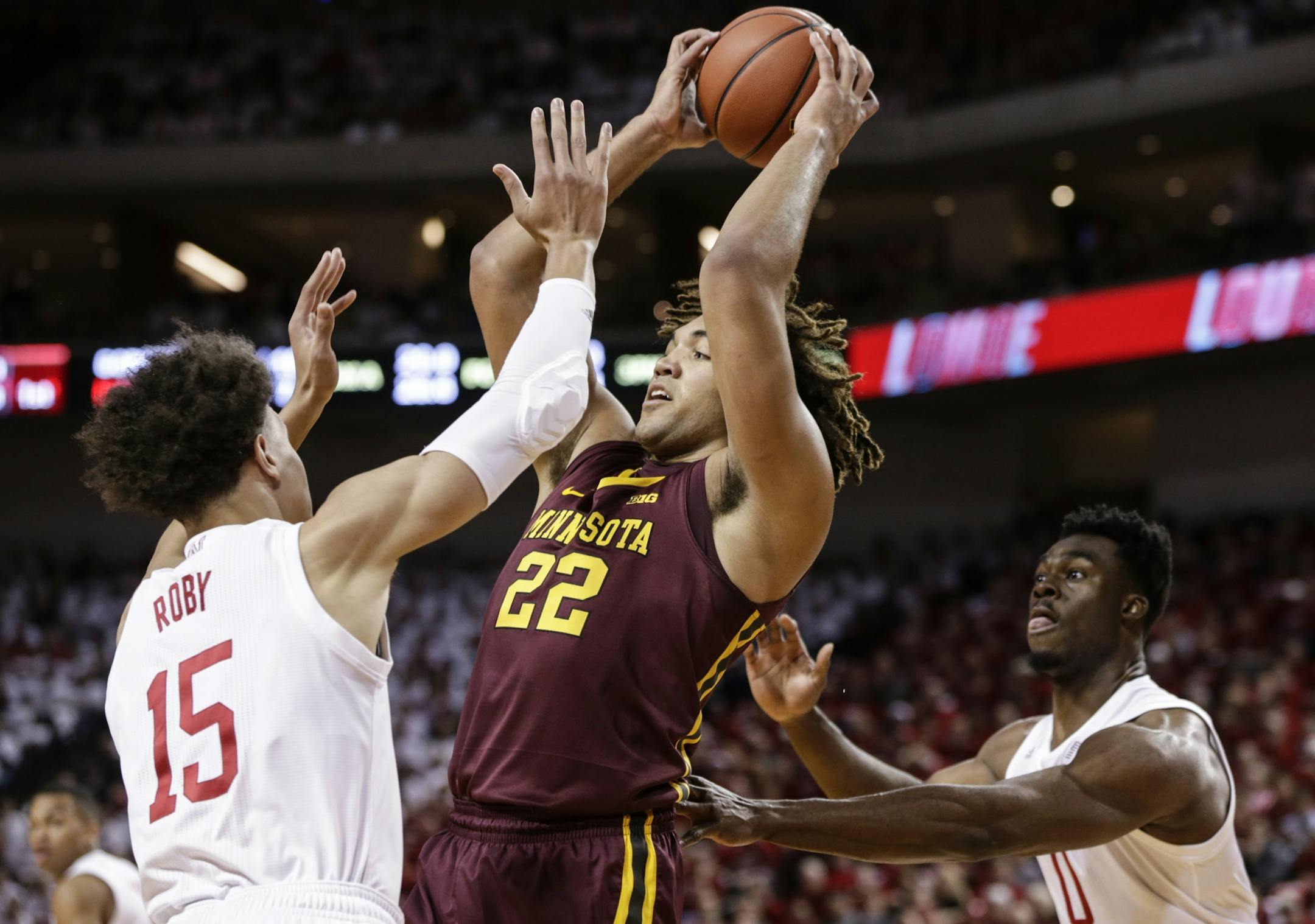 Minnesota's Reggie Lynch (22) wins a rebound between Nebraska's Isaiah Roby (15) and Duby Okeke (0) during the first half of an NCAA college basketball game in Lincoln, Neb., Tuesday, Dec. 5, 2017.