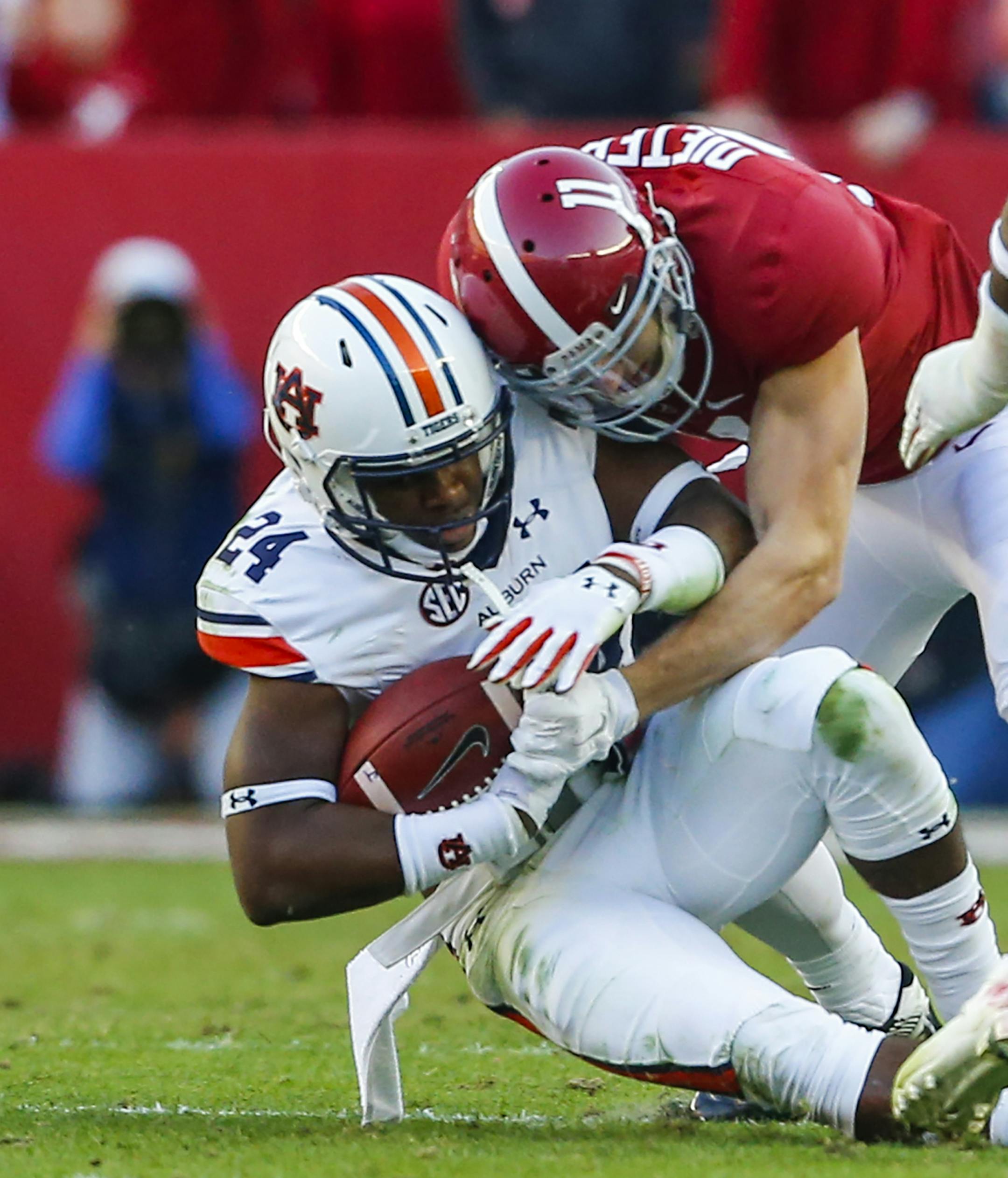 Auburn defensive back Daniel Thomas (24) is tackled by Alabama wide receiver Gehrig Dieter (11) after an interception during the first half of the Iron Bowl NCAA college football game, Saturday, Nov. 26, 2016, in Tuscaloosa, Ala. (AP Photo/Butch Dill)