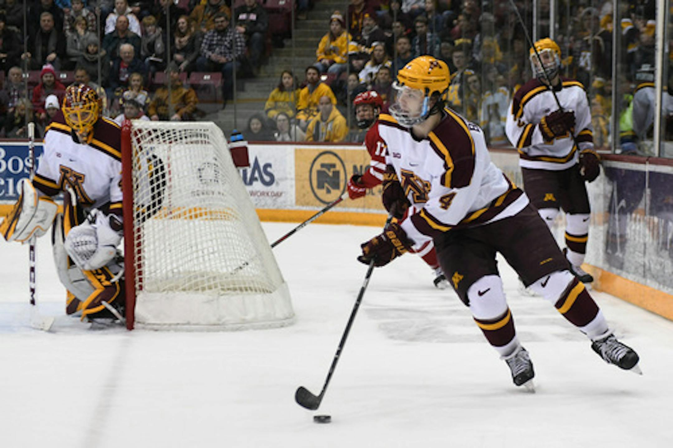 Minnesota Golden Gophers defenseman Ben Brinkman (4) kept the puck away from Wisconsin in the second period. ] COURTNEY DEUTZ • courtney.deutz@startribune.com