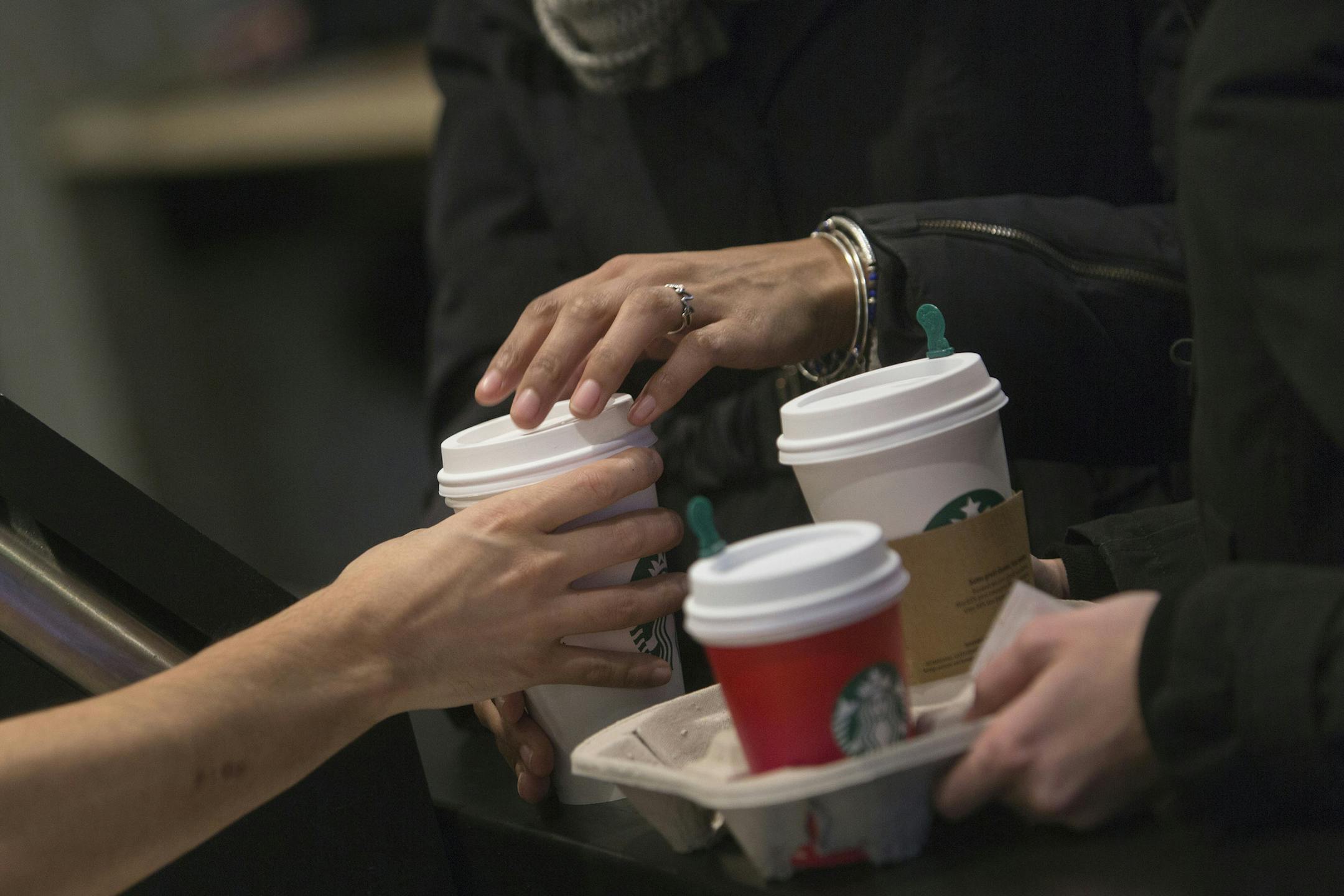 A barista hands a customer a drink inside a Starbucks Corp. coffee shop in New York on Jan. 18, 2016. MUST CREDIT: Bloomberg photo by Victor J. Blue.