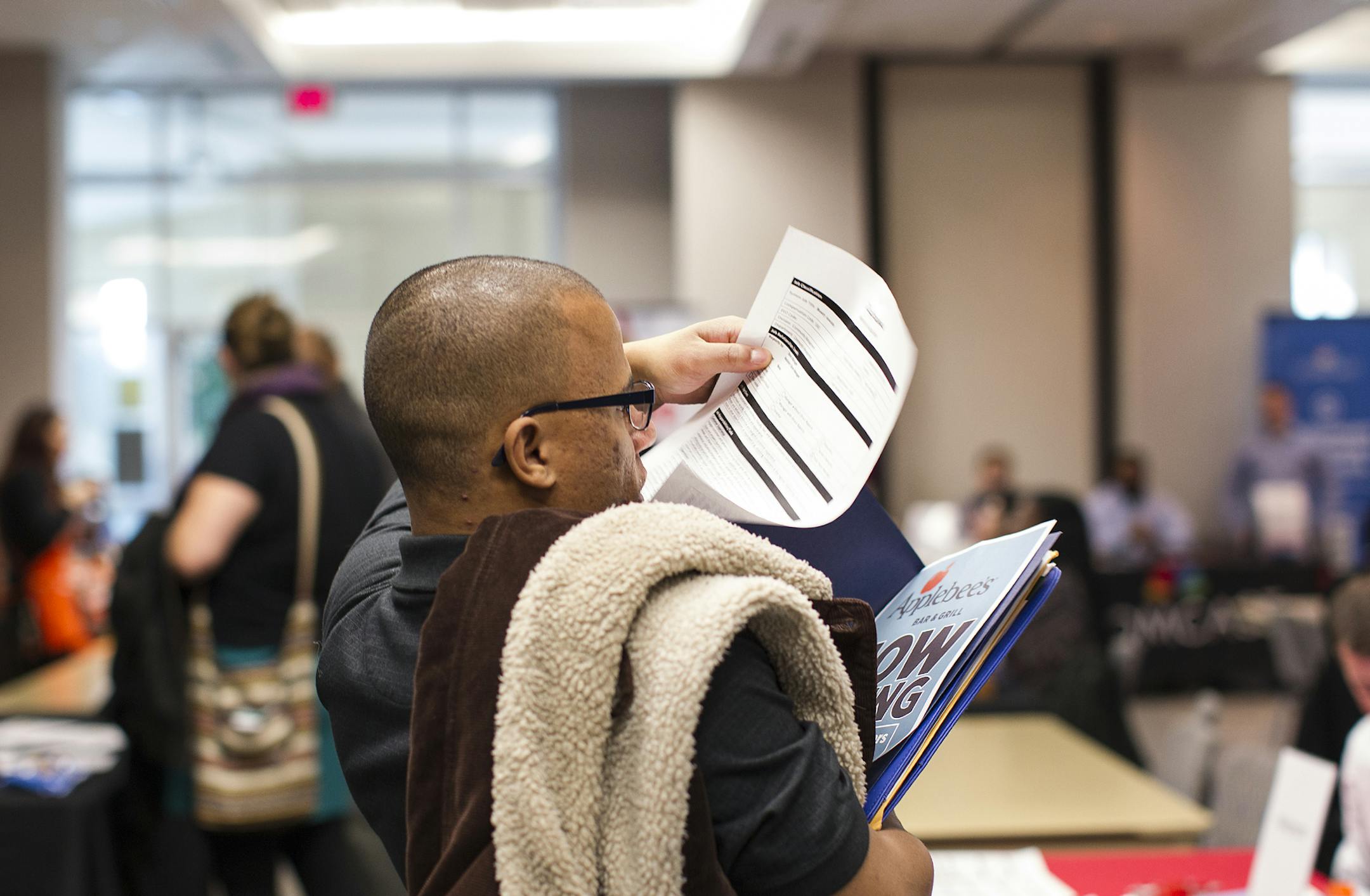 Marcus Sable of Blaine puts his collected papers in order during a Job Development Career Fair at Brookdale Library in Brooklyn Center December 7, 2015. Sable came seeking employment opportunities. (Courtney Perry/Special to the Star Tribune)
