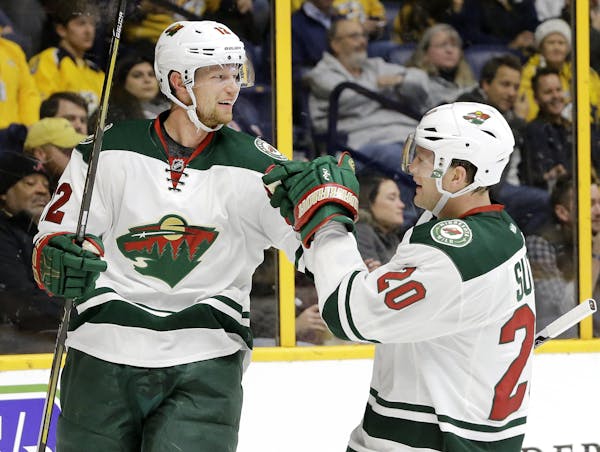 Minnesota Wild center Eric Staal (12) celebrates with Ryan Suter (20) after Staal scored a goal against the Nashville Predators during the first perio