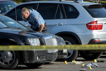 A Minneapolis police officer investigated the scene of a homicide earlier this year.