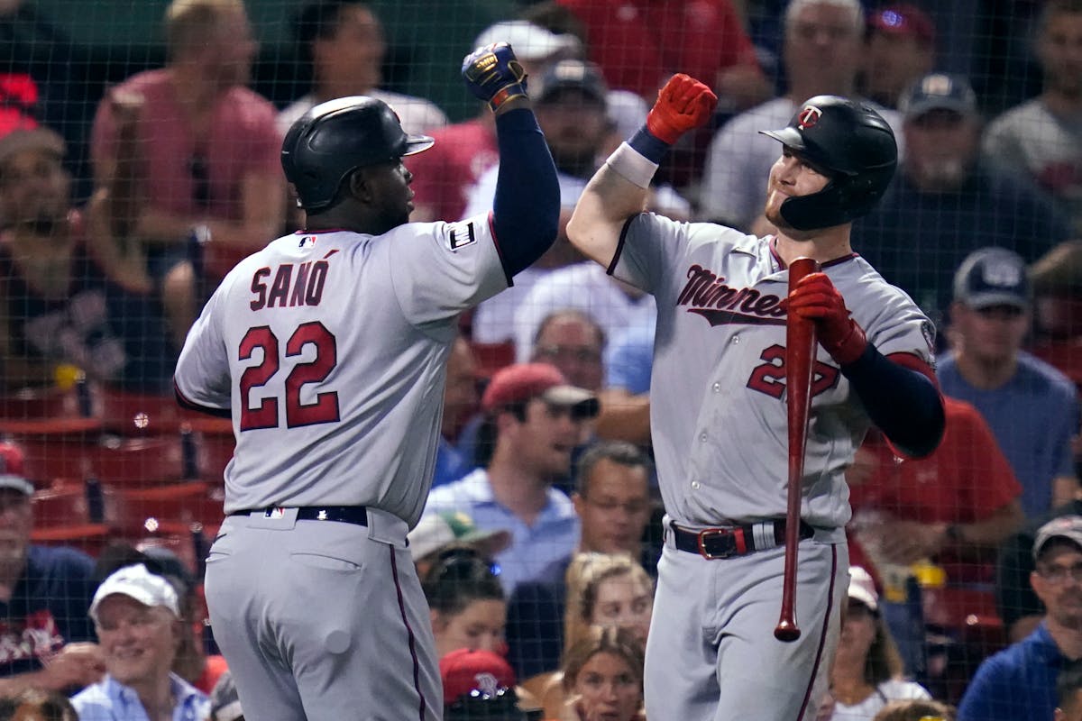 Minnesota Twins' Miguel Sano, left, celebrates with Ryan Jeffers after his solo home run off Boston Red Sox starting pitcher Nick Pivetta during the t